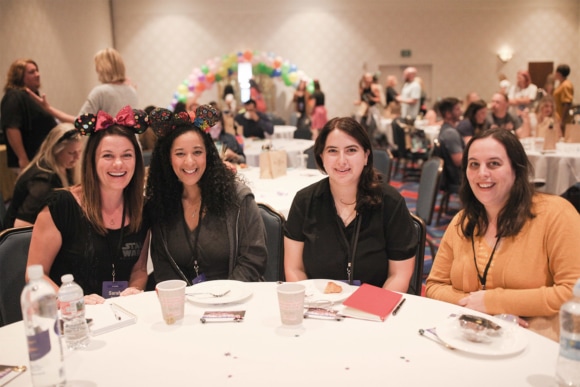 FLOCK attendees sitting at an event during a break